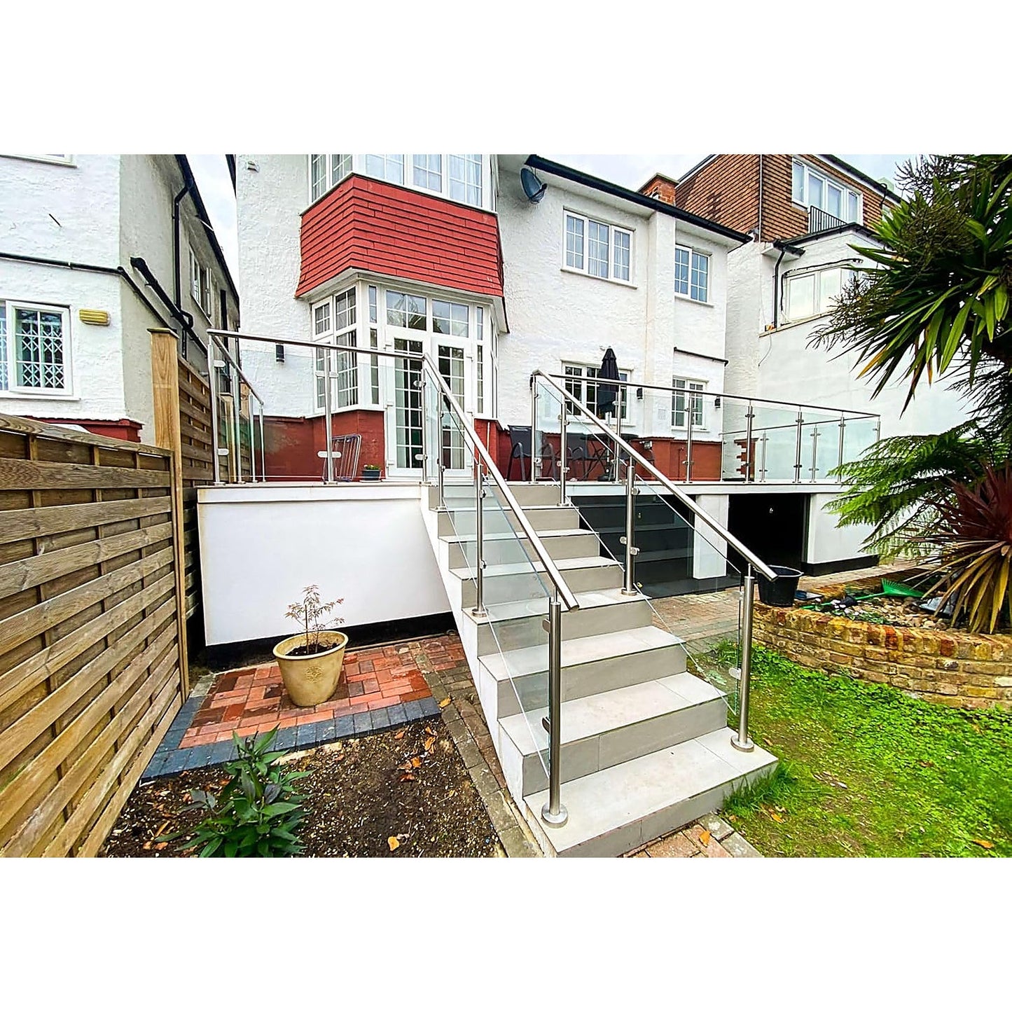 Glass balustrade with 316 stainless steel handrail installed